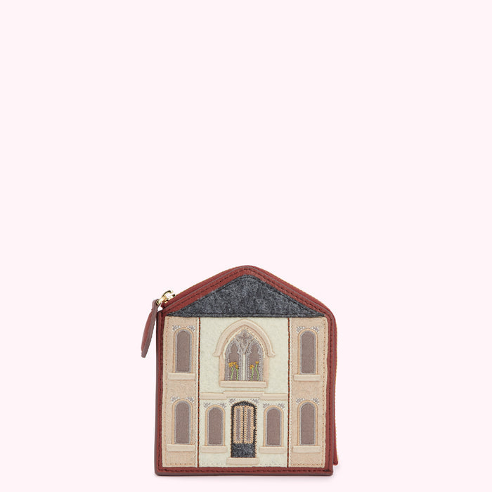Brown leather purse shaped like a house with embroidered details.