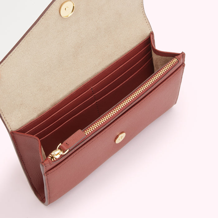A brown leather wallet open to reveal its interior compartments and gold zipper.