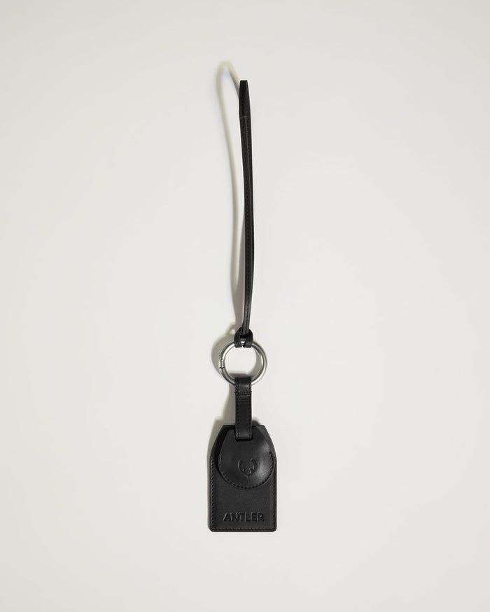 a black leather keychain with a key ring