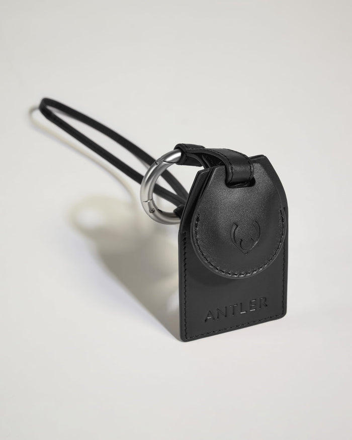 a black leather keychain with a silver ring