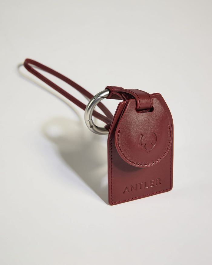 a red leather keychain with a silver ring