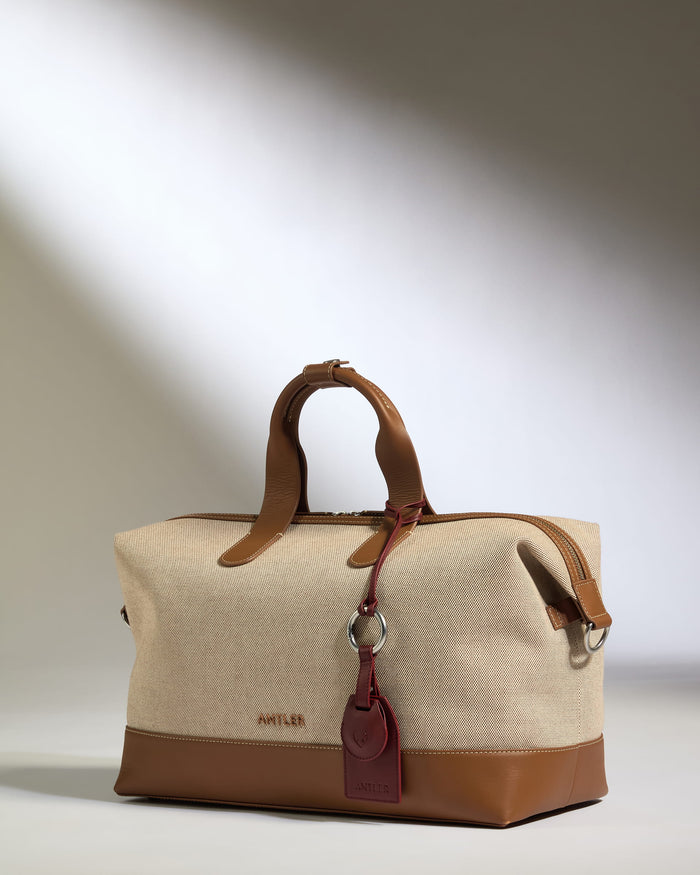 a brown and tan bag with a red tag
