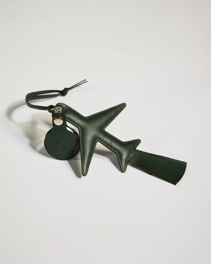 a green leather airplane keychain