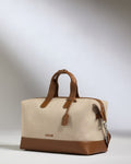 a bag with brown leather handles