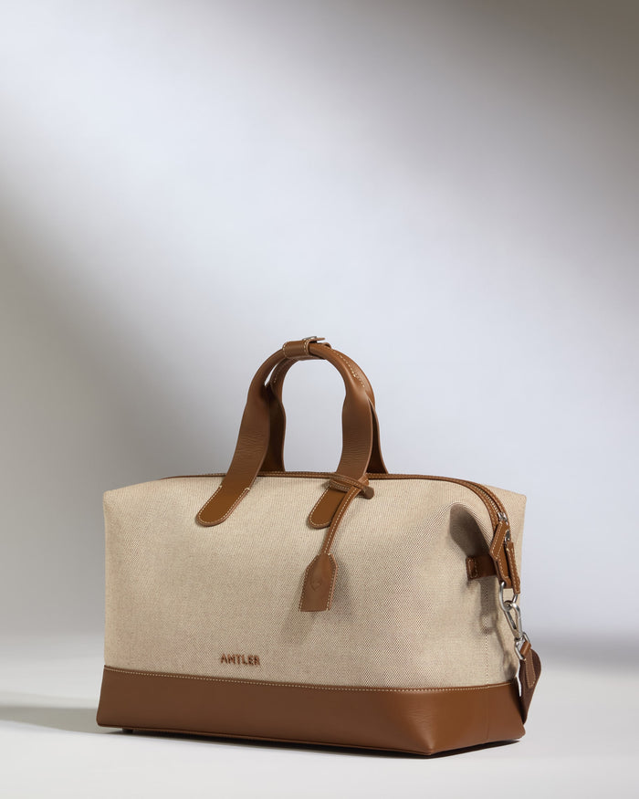 a bag with brown leather handles