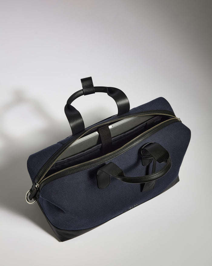 a blue bag with a black strap
