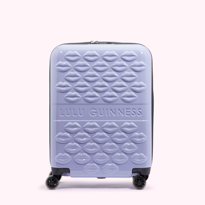 Lilac Lulu Guinness suitcase covered in embossed lips.