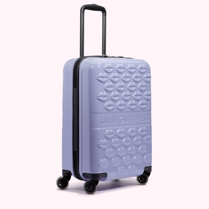 Lilac Lulu Guinness suitcase with a lip print design.
