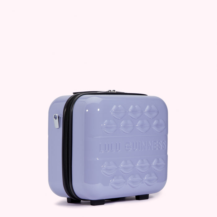 Lilac Lulu Guinness makeup case with lip design.