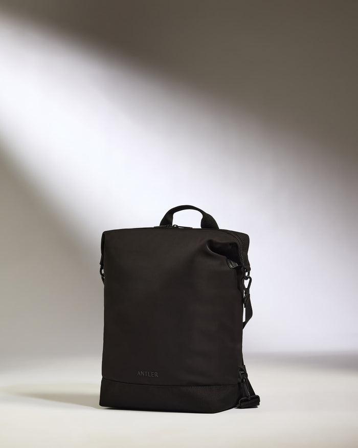 a black backpack with a strap