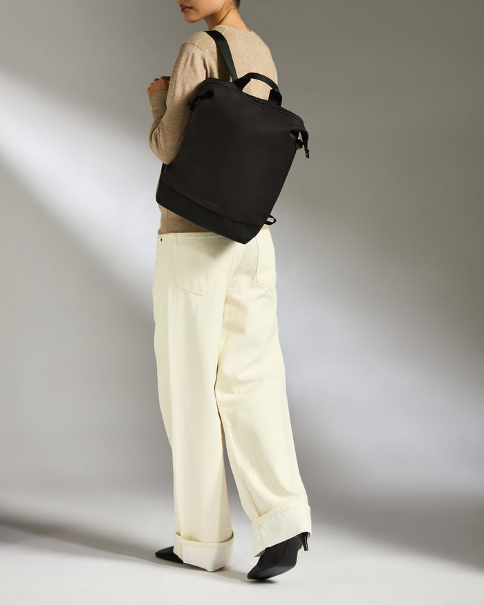 a woman wearing a black backpack