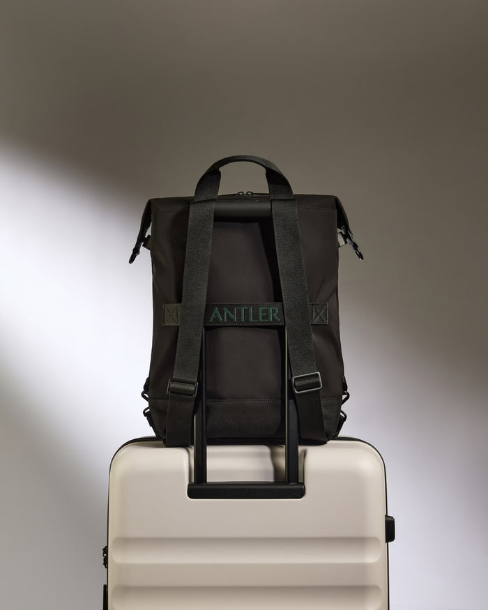 a black bag on a white suitcase
