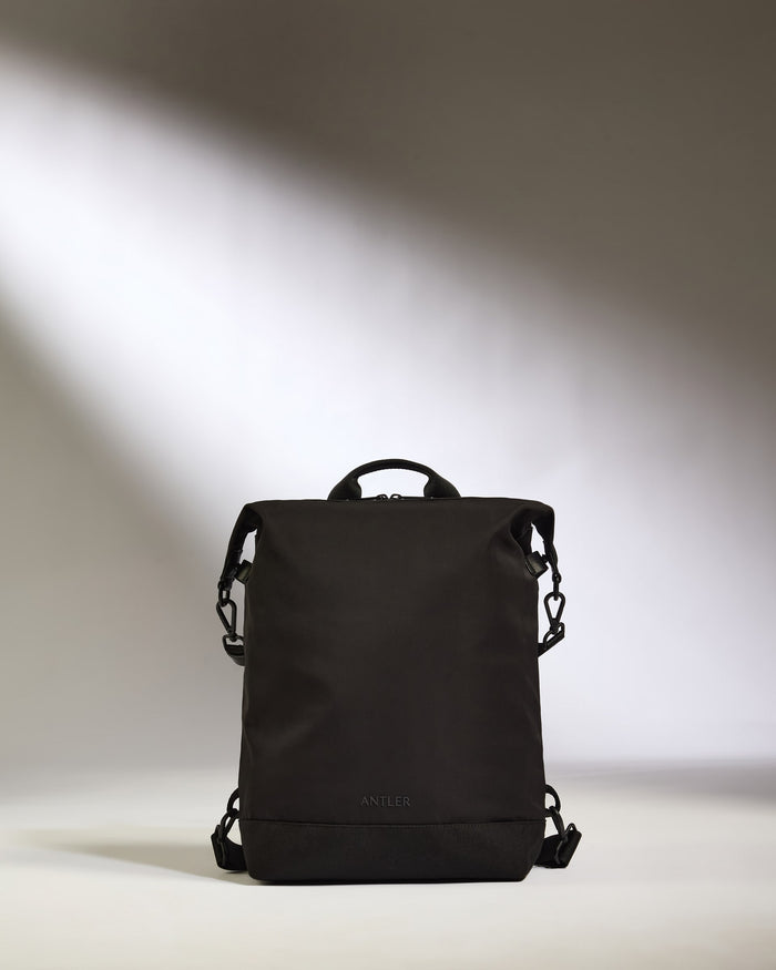 a black backpack with a strap
