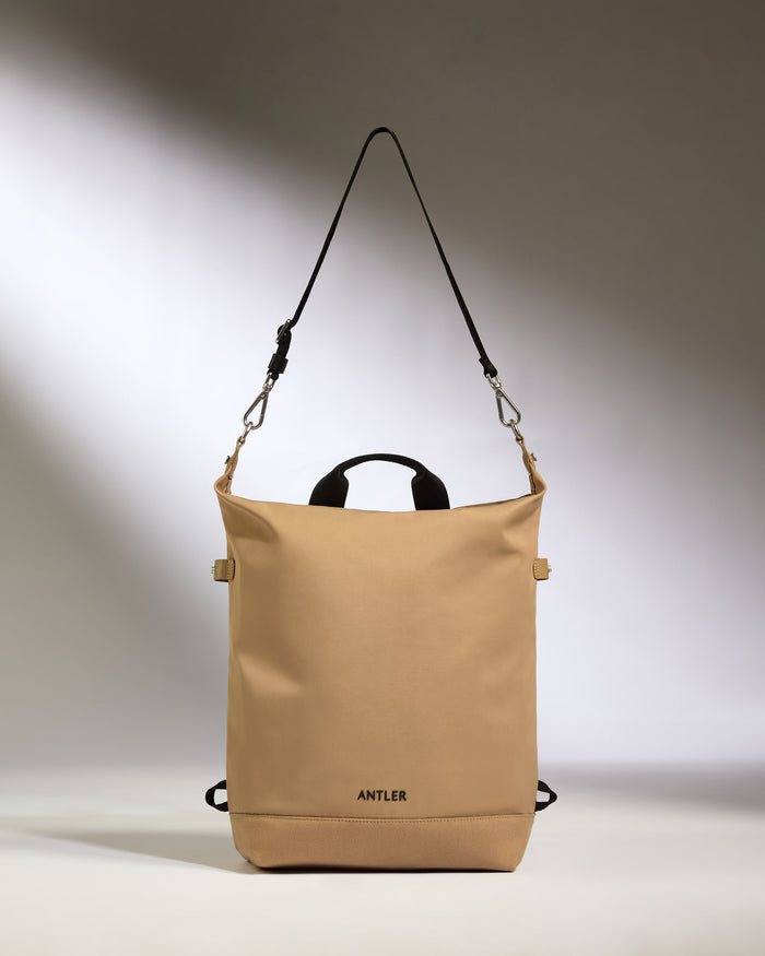 a tan bag with black straps