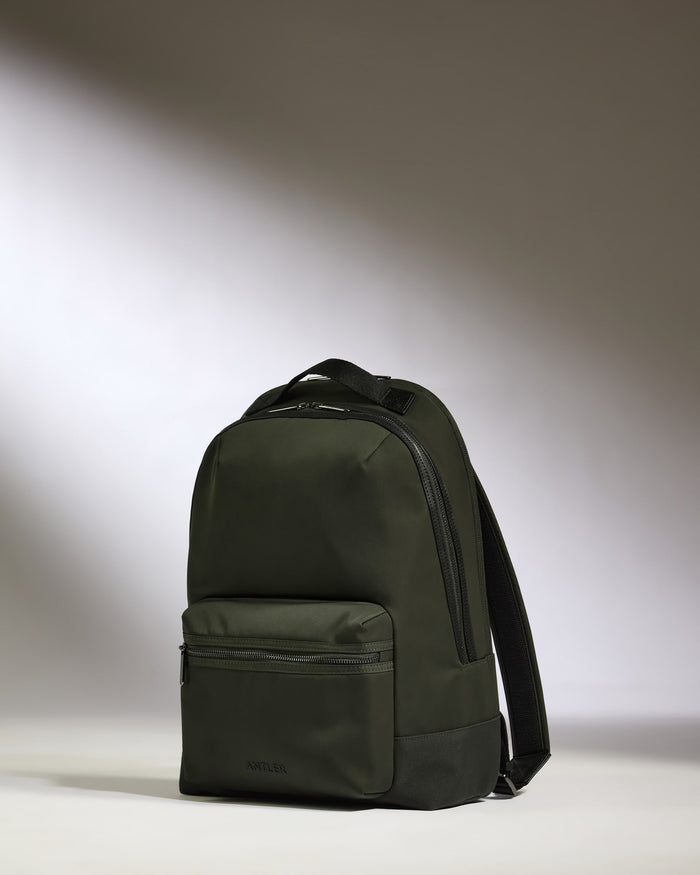 a black backpack on a white surface