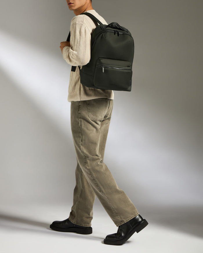 a man walking with a backpack