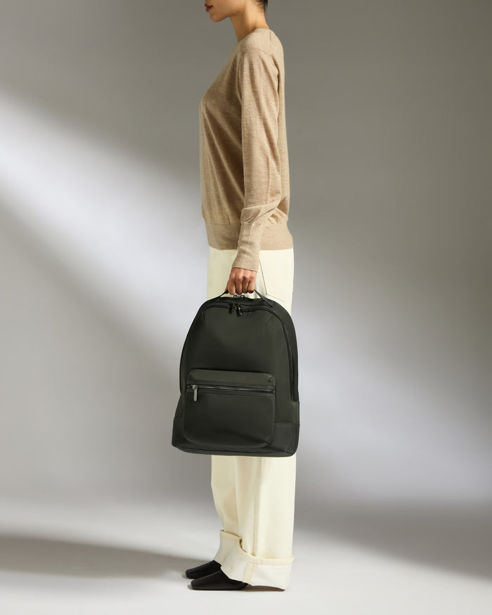 a woman holding a backpack