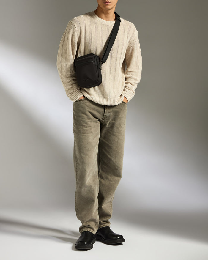a man standing with his hands in his pockets