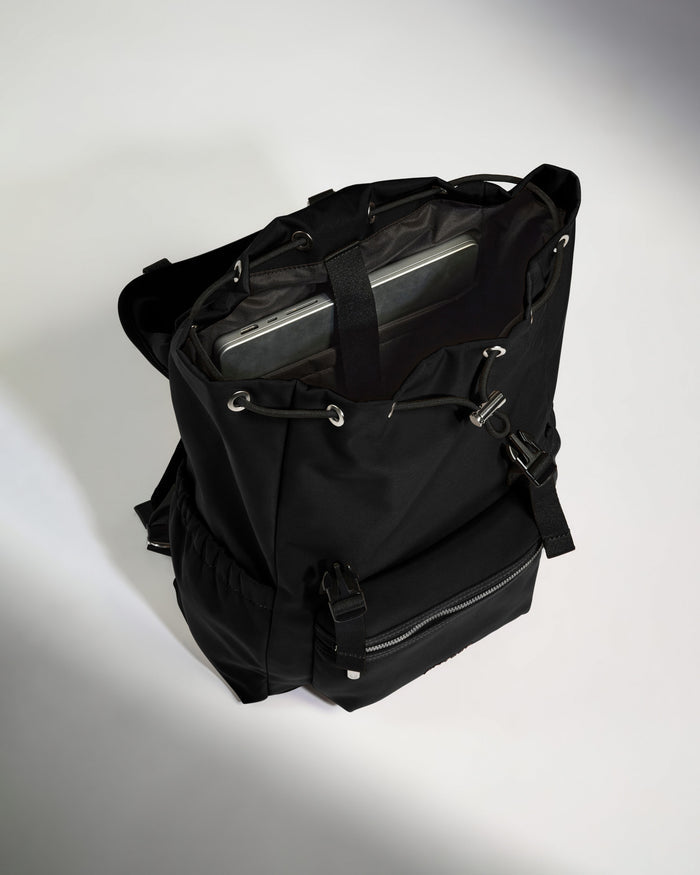 a black backpack with a laptop inside