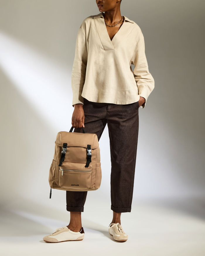 a woman holding a backpack
