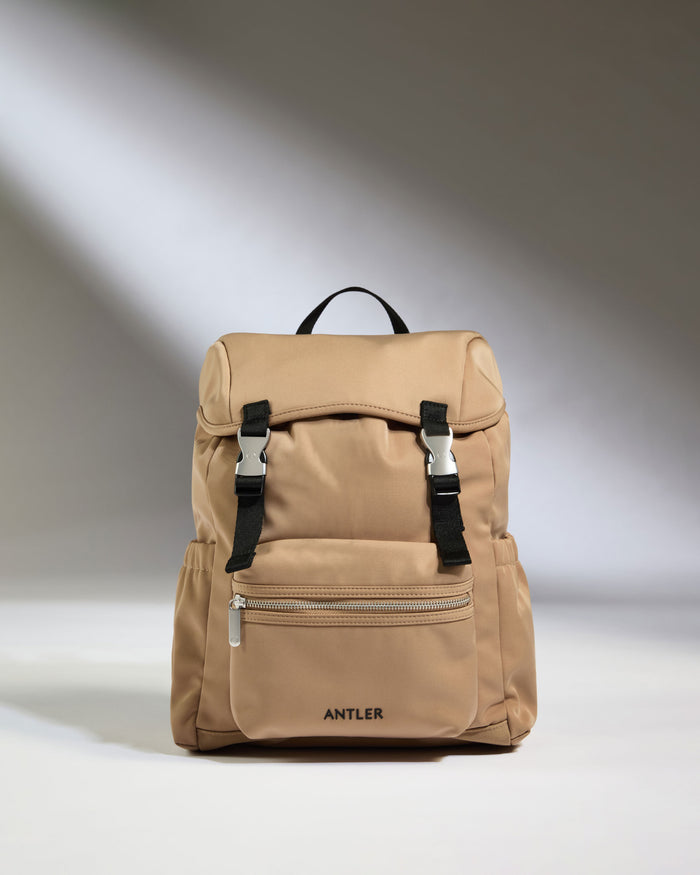 a tan backpack with black straps