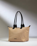 a beige bag with black handles