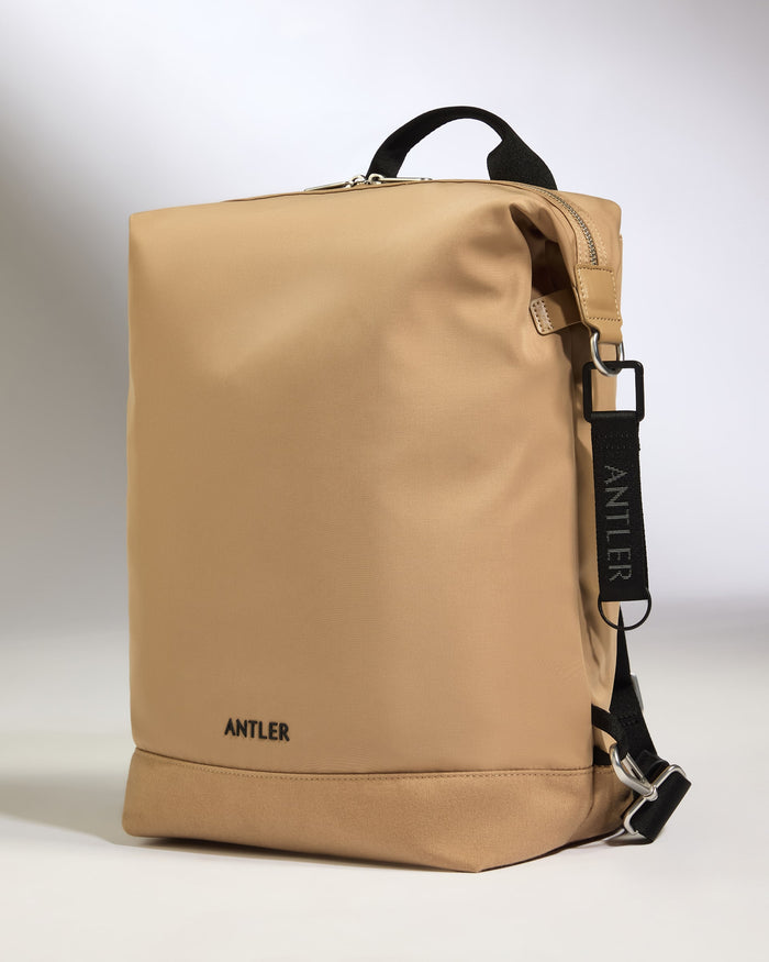 a tan bag with black straps