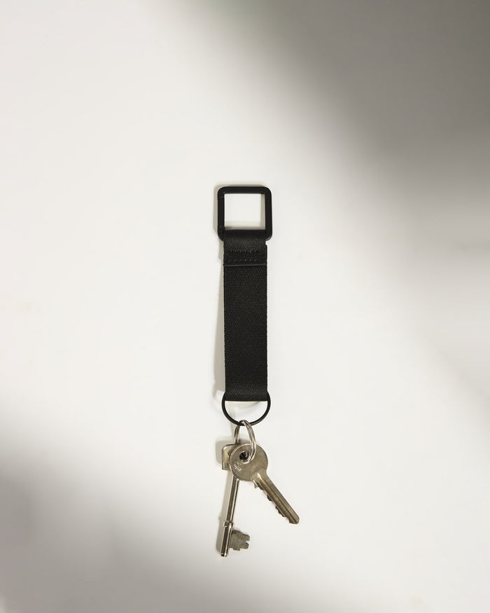 a set of keys on a black strap