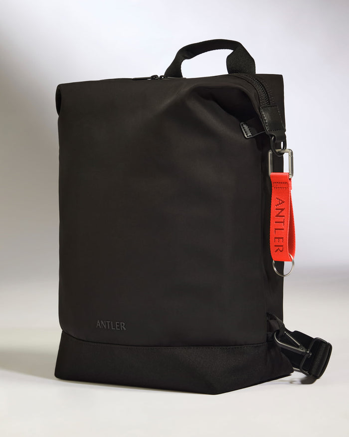 a black bag with a red strap