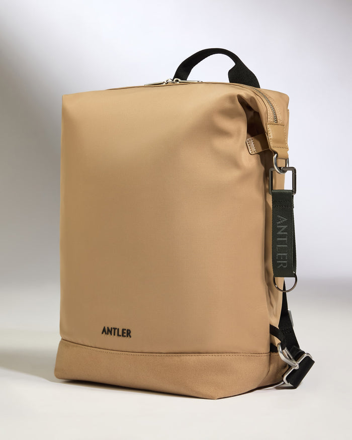 a tan bag with black straps