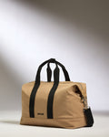 a tan bag with black straps