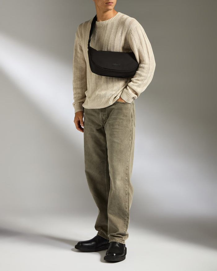 a man in a sweater and pants