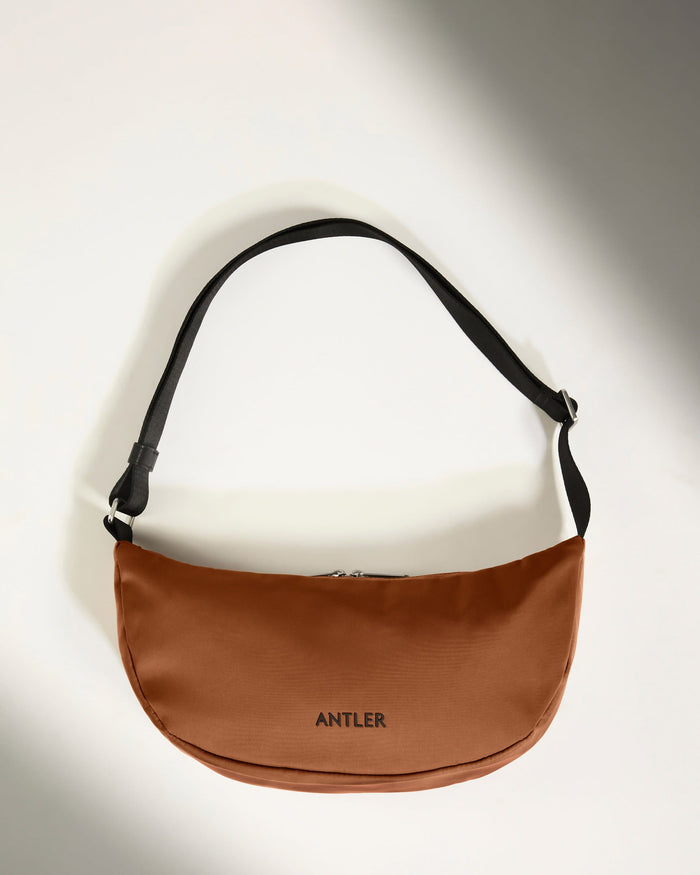 a brown bag with a black strap