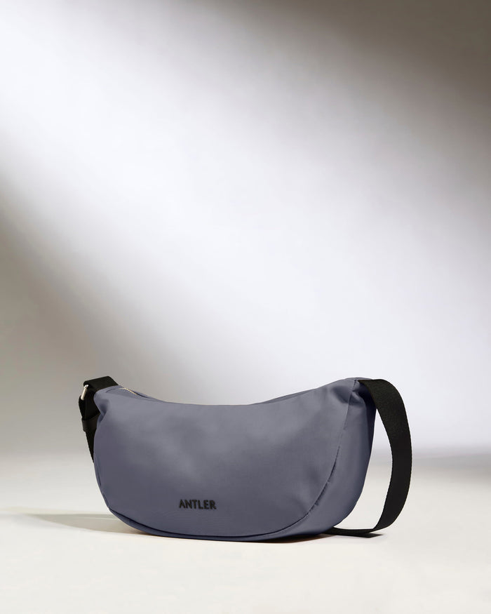 a grey bag with black straps