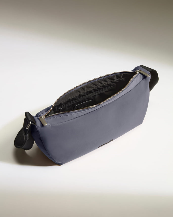 a small blue bag with a black strap