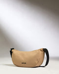 a tan bag with black strap