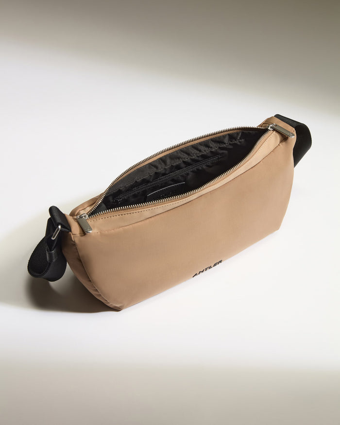 a tan bag with black straps