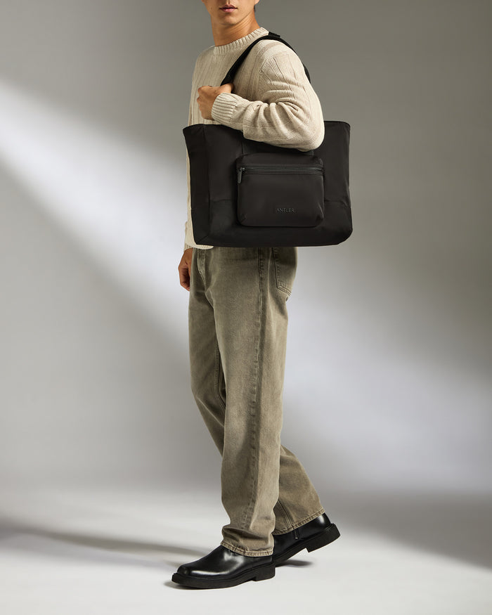 a man carrying a black bag