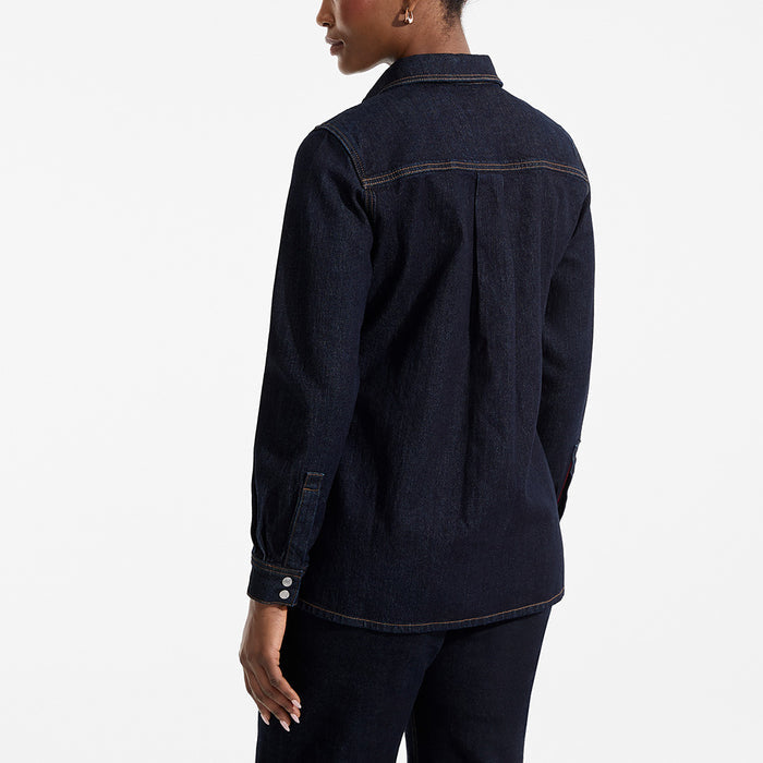 Person wearing a dark denim shirt on a white background