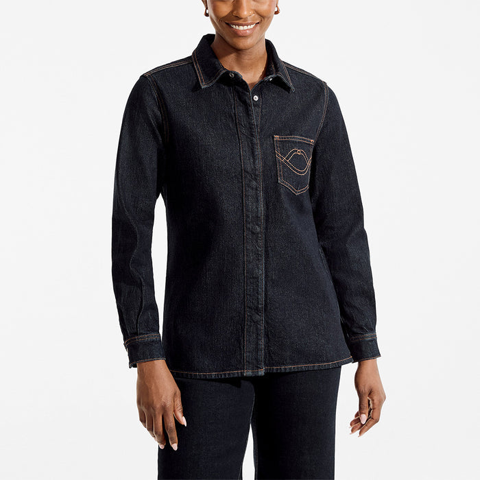 Person wearing a dark denim shirt on a white background