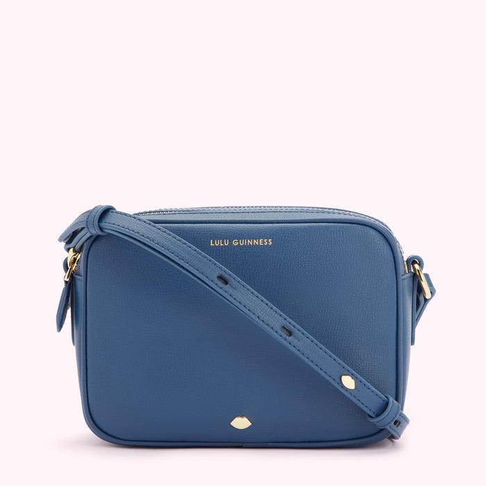 A blue Lulu Guinness crossbody bag with a gold logo and adjustable strap.