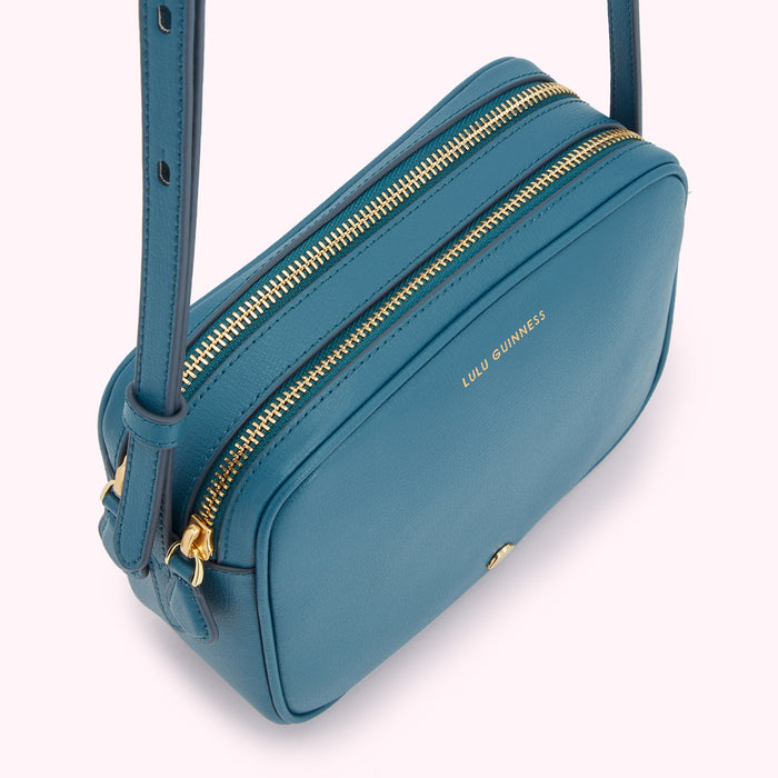 Teal Lulu Guinness crossbody bag with gold zippers.