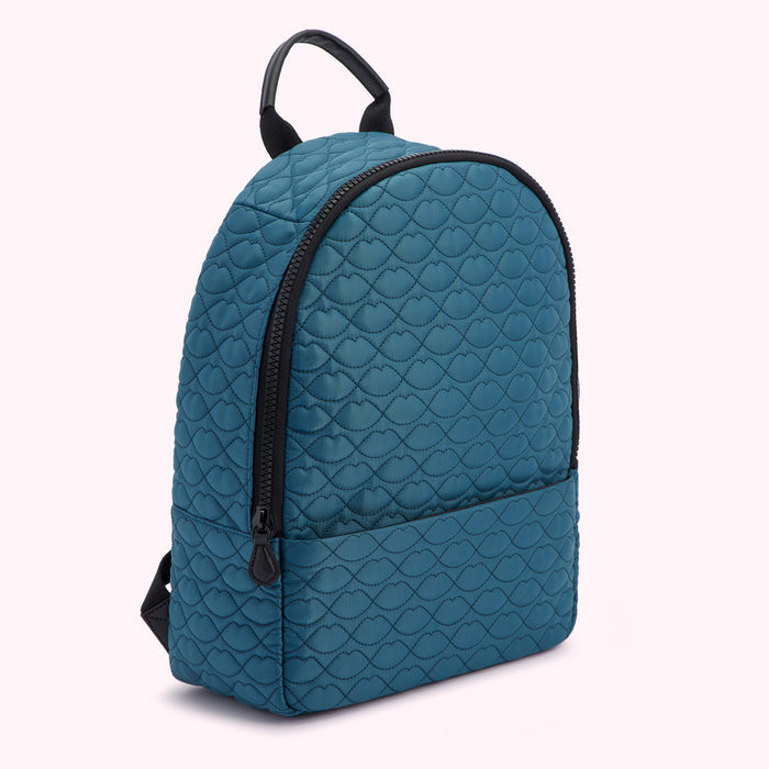 Teal quilted backpack with black zipper and straps, featuring a lip print.