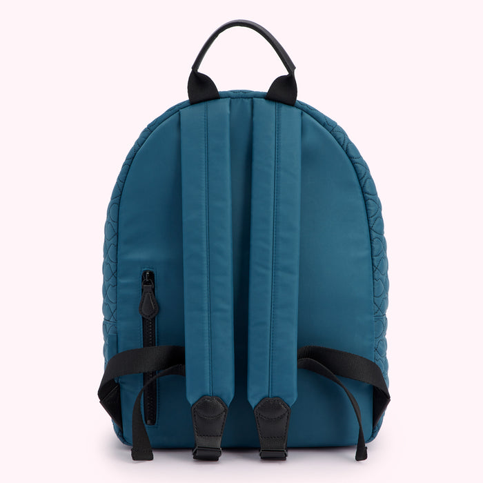 Teal quilted backpack with black straps and zipper. Back view.