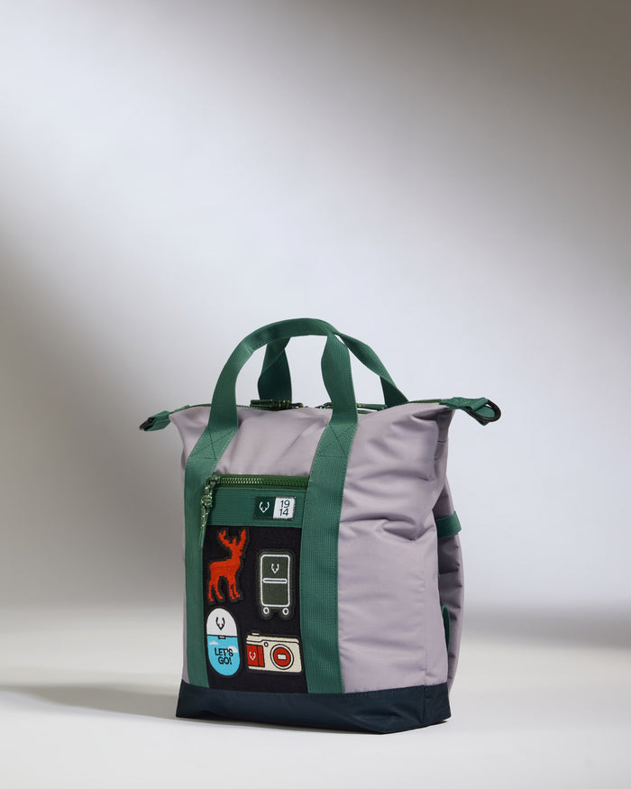 a grey and green bag with a green strap