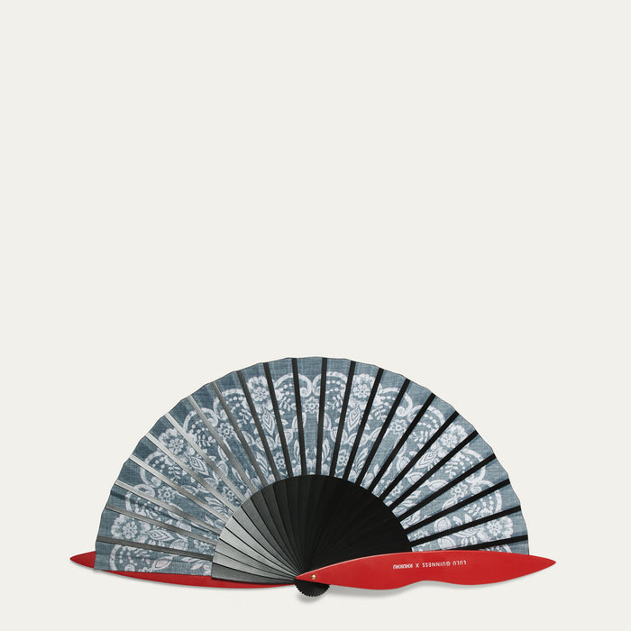 Handheld fan with decorative lace pattern on a light gray background