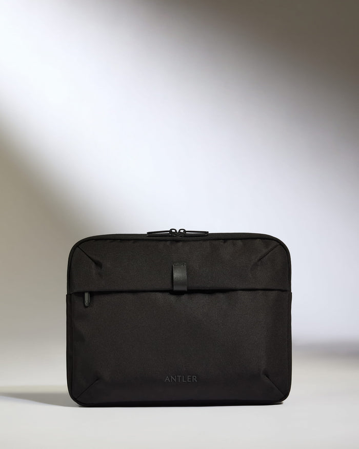 a black bag on a white surface