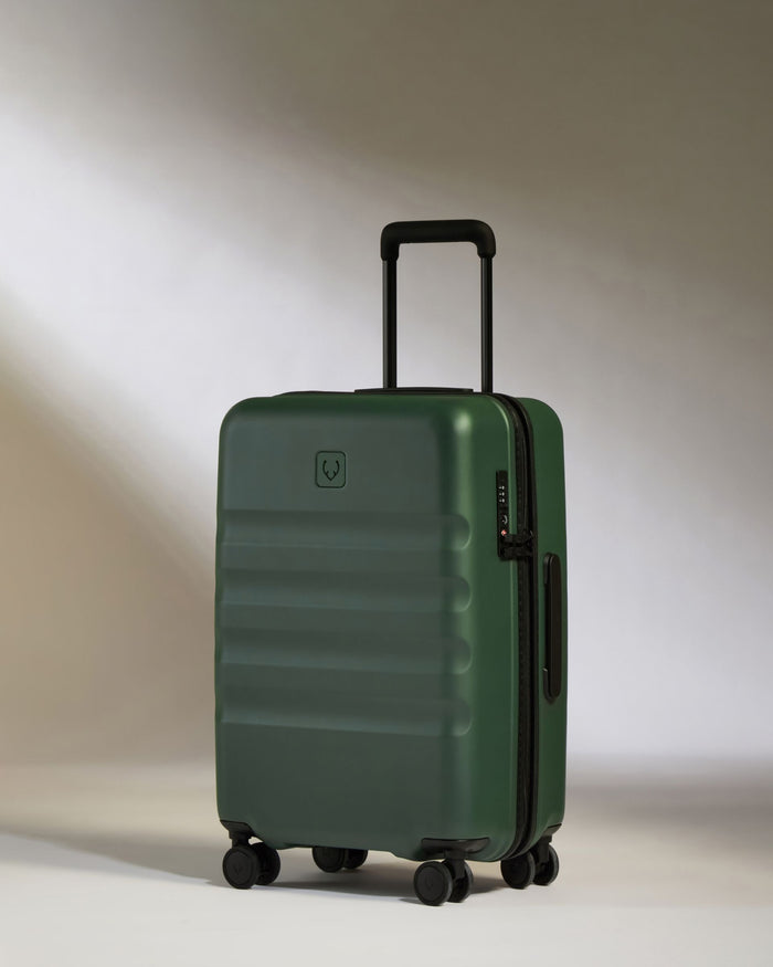 a green suitcase with wheels