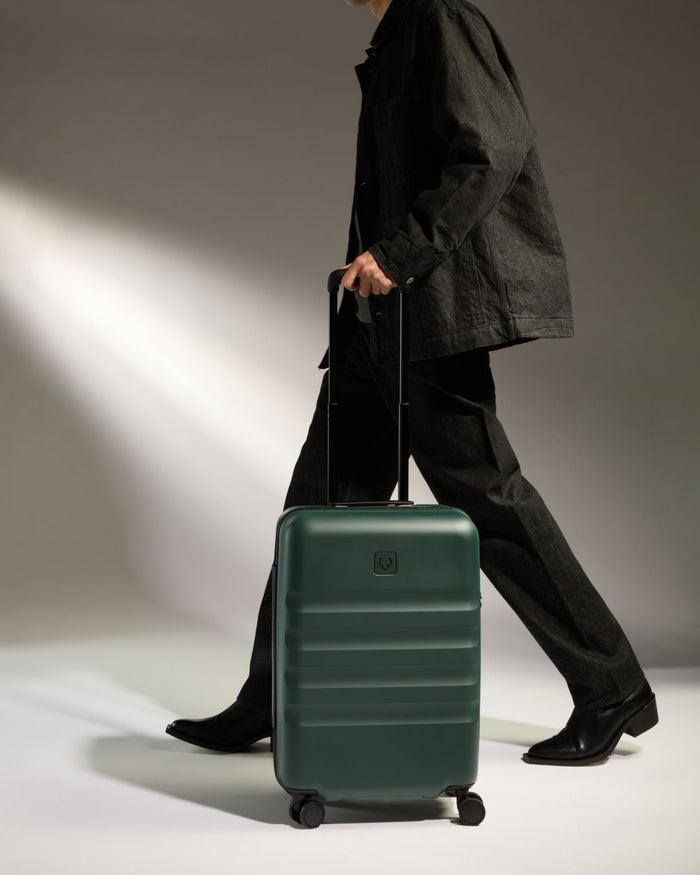 a person with a green suitcase