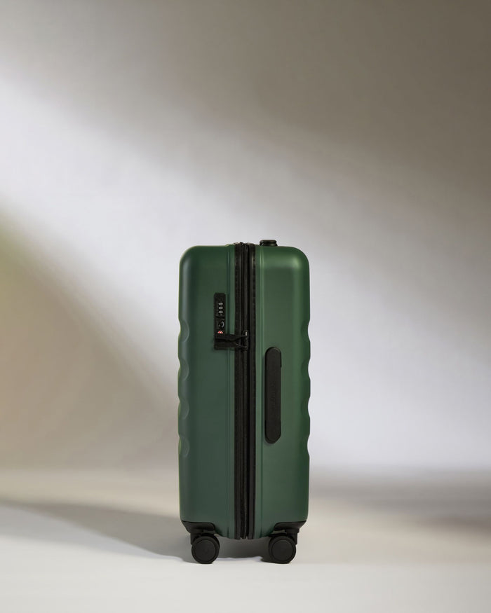 a green suitcase with wheels